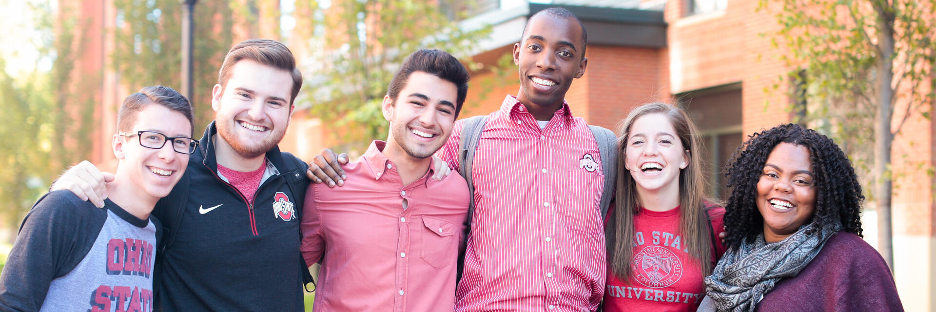 Smiling students standing together on campus